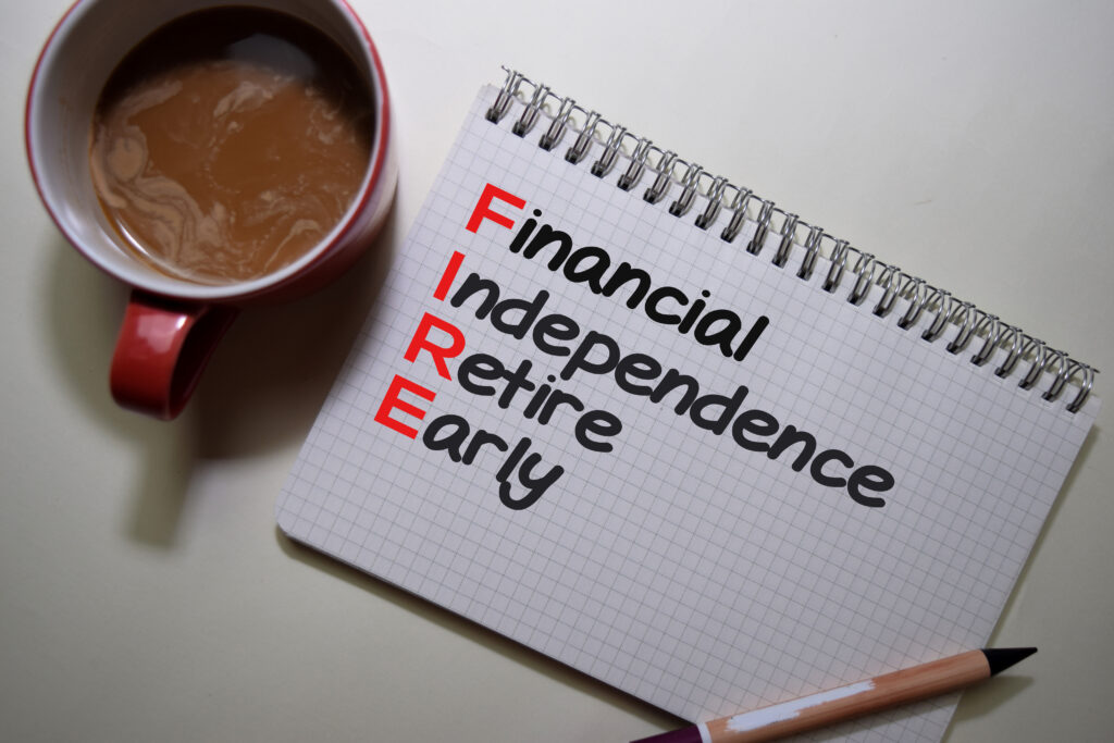 Financial Indipendence Retire Early write on a book isolated on Office Desk.